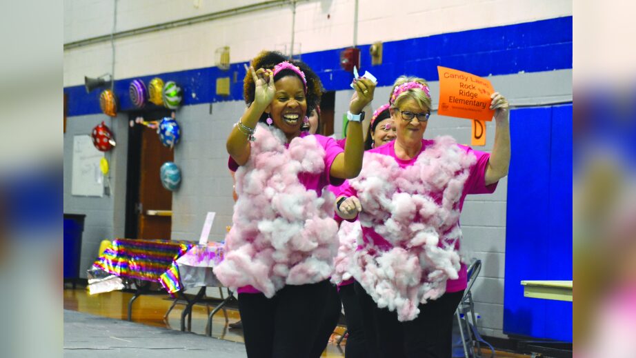 Rock Ridge Elementary School teachers Gloria Johnson, left, and Jane Bass wave to the crowd during last year's Wilson Education Partnership's annual Adult Trivia and Spelling Bee fundraiser. Olivia Neeley | Times file photo